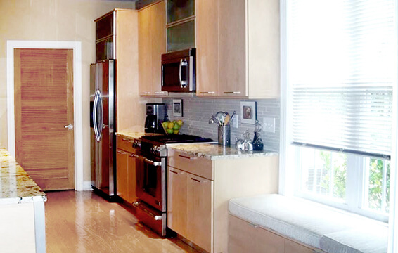 A love story about a contemporary style kitchen with a slab door style and light stained cabinets.