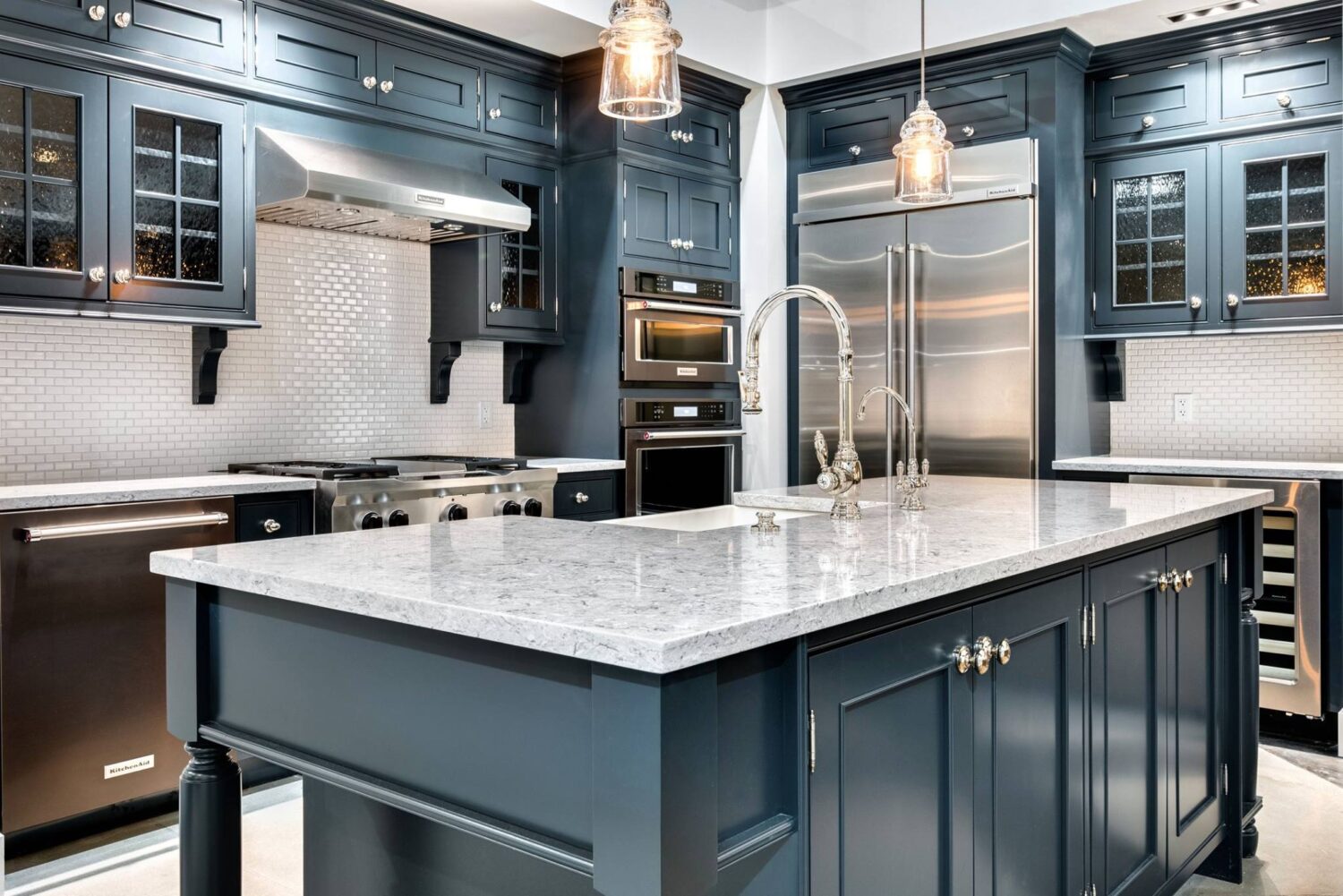 A traditional styled kitchen design with all black cabinets and furniture style kitchen island.