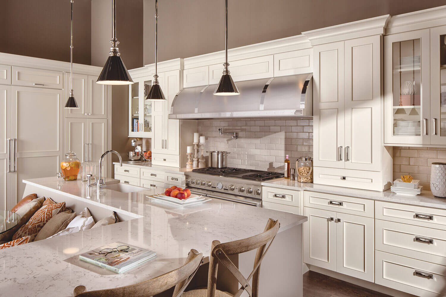 A beautiful L-shaped kitchen with an L-shaped kitchen island with a built-in breakfast nook integrated into the island.