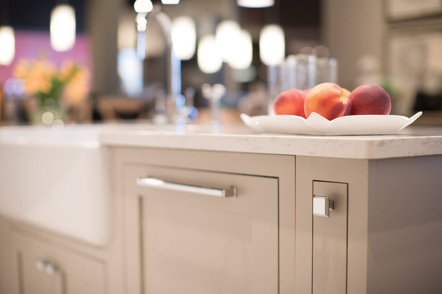 A beige kitchen island with shaker styled inset cabinets from Dura Supreme.