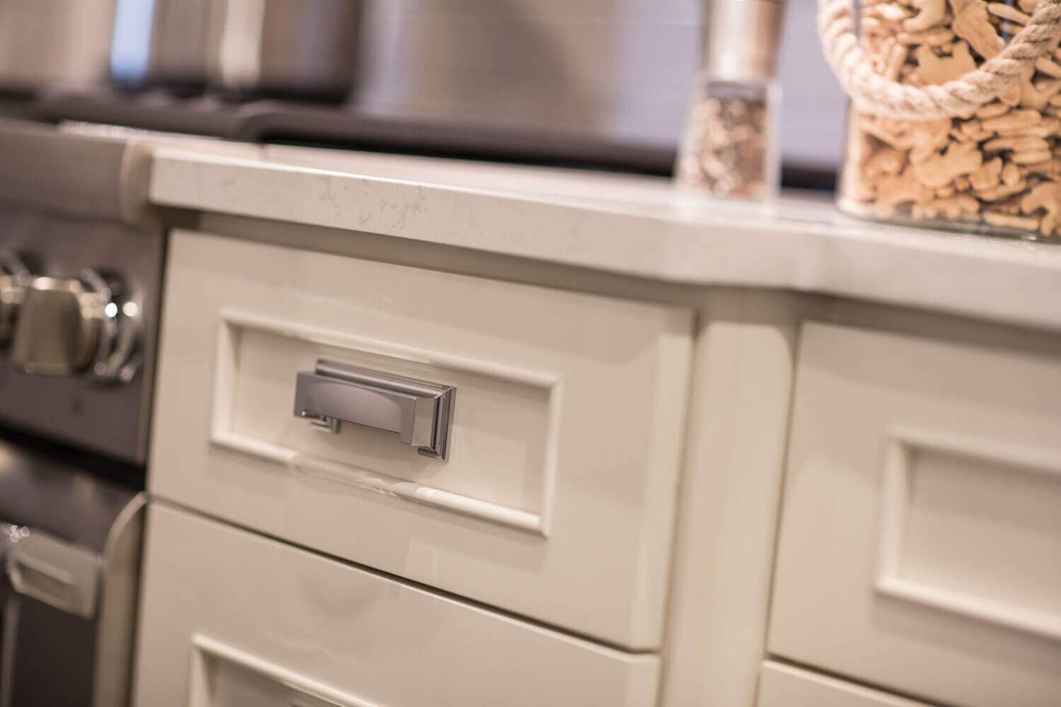 A close of the white painted cabinets with a beautiful, simple molding that emphasizes the flat panel door style.