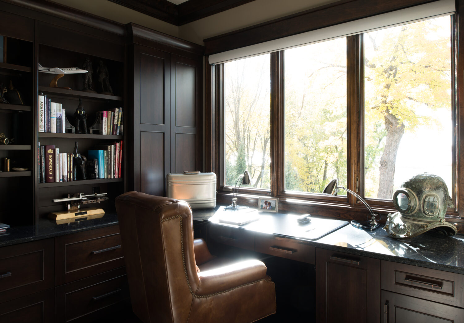 A traditional, formal home office design with a little industrial steampunk styling.