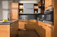 A contemporary style kitchen with warm bamboo cabinets from Dura Supreme Cabinetry.