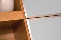 A close-up of frameless bamboo cabinets with modern aluminum framed metal accent doors.