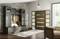 Entryway with mudroom lockers and dark green painted cabinetry with a metal accent cabinet door and wood plank details. Dura Supreme Cabinetry with a trendy painted finish, Rock Bottom green.