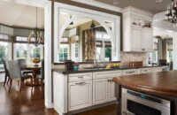 An arched opening in the kitchen wall looks into the dining room space.