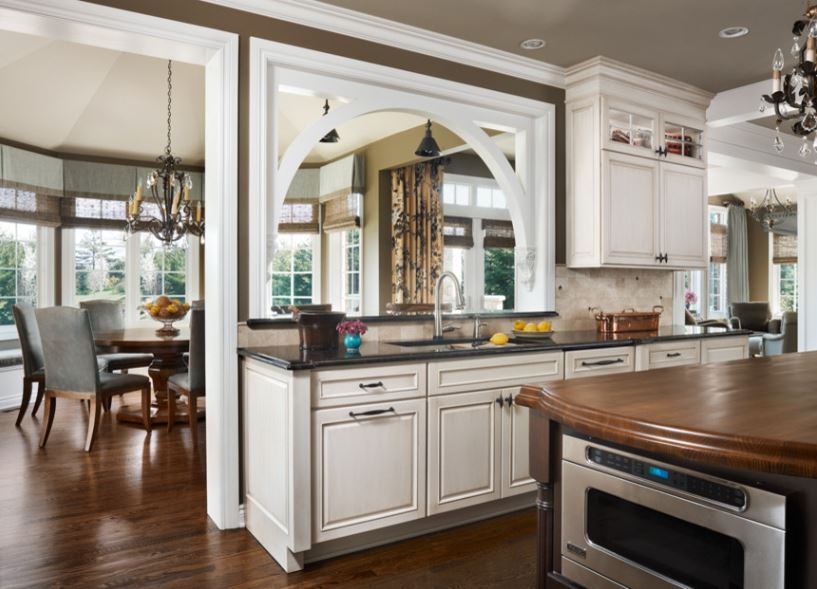 An arched opening in the kitchen wall looks into the dining room space.