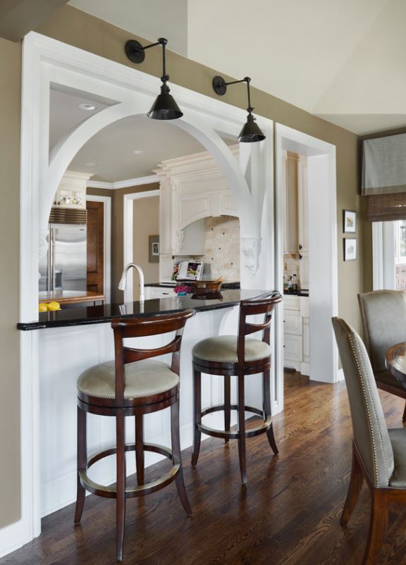 The other side of the arched opening in the wall of the kitchen as bar height seating.