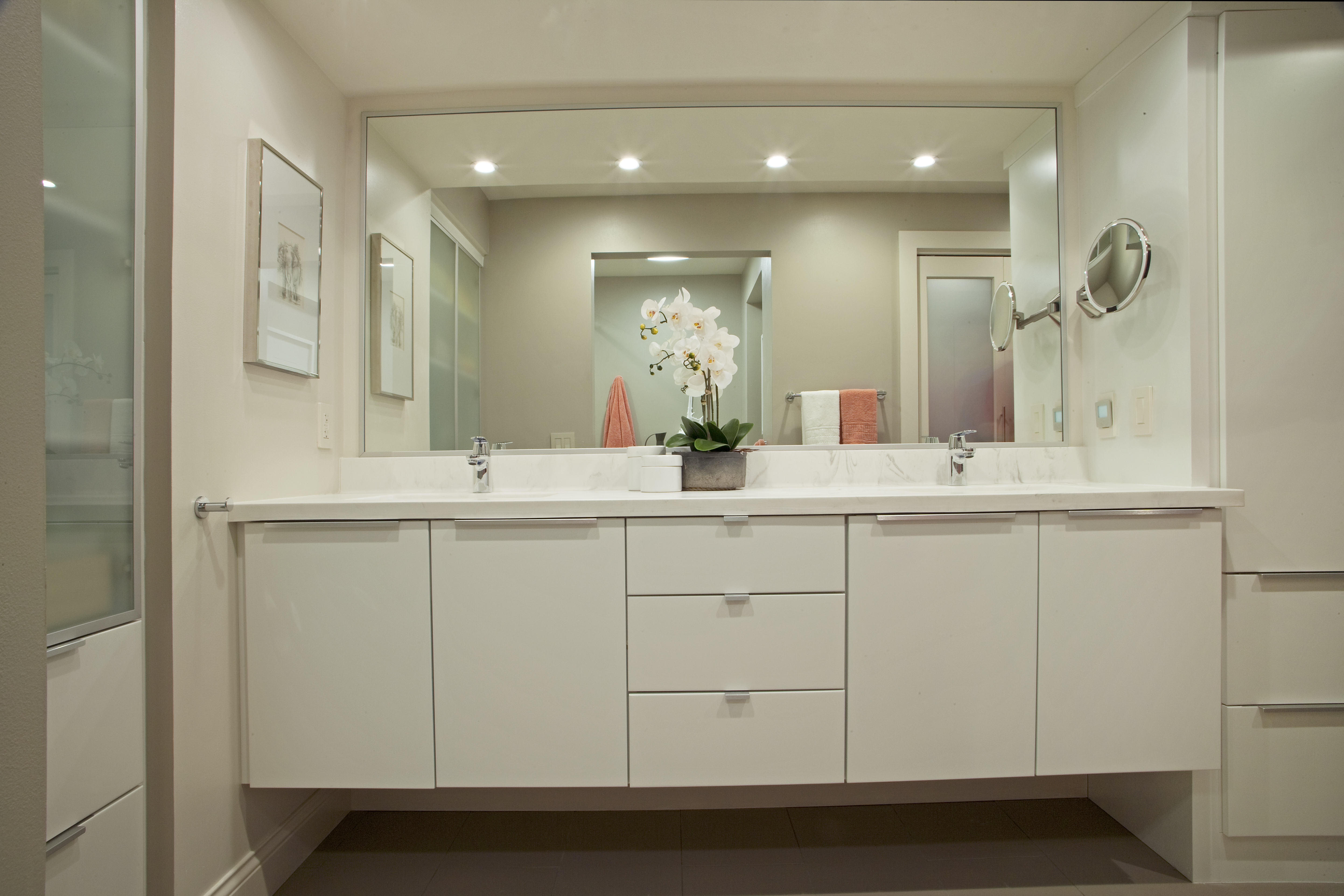 A fresh all-white, contemporary bathroom design by Dan Luck of Bella Domicile featuring Dura Supreme Cabinetry.