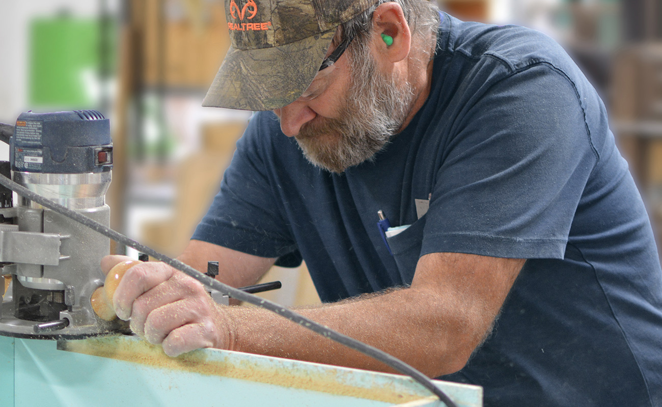 A cabinet maker hard at work, crafting semi-custom and custom cabinetry for Dura Supreme Cabinetry. Dura Supreme cabinetry offers the best in value, design, quality, and craftsmanship.