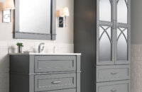 Dark gray bathroom furniture set with a vanity and a free-standing linen cabinet with decorative mirror cabinet doors.