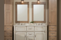 A rustic, shabby chic styled bathroom furniture collection with one double sink vanity and two free-standing linen cabinets on each side.