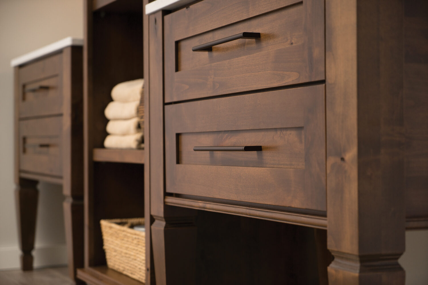 A 3-piece-set of bathroom furniture with two vanities and a free-standing linen cabinet.