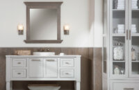 A coastal style master bathroom with a freestanding furniture style vanity that was customized to fit the homeowner's style preferences. The cool gray finish looks crisp and fresh against the weathered wood wall panels and vanity mirror.