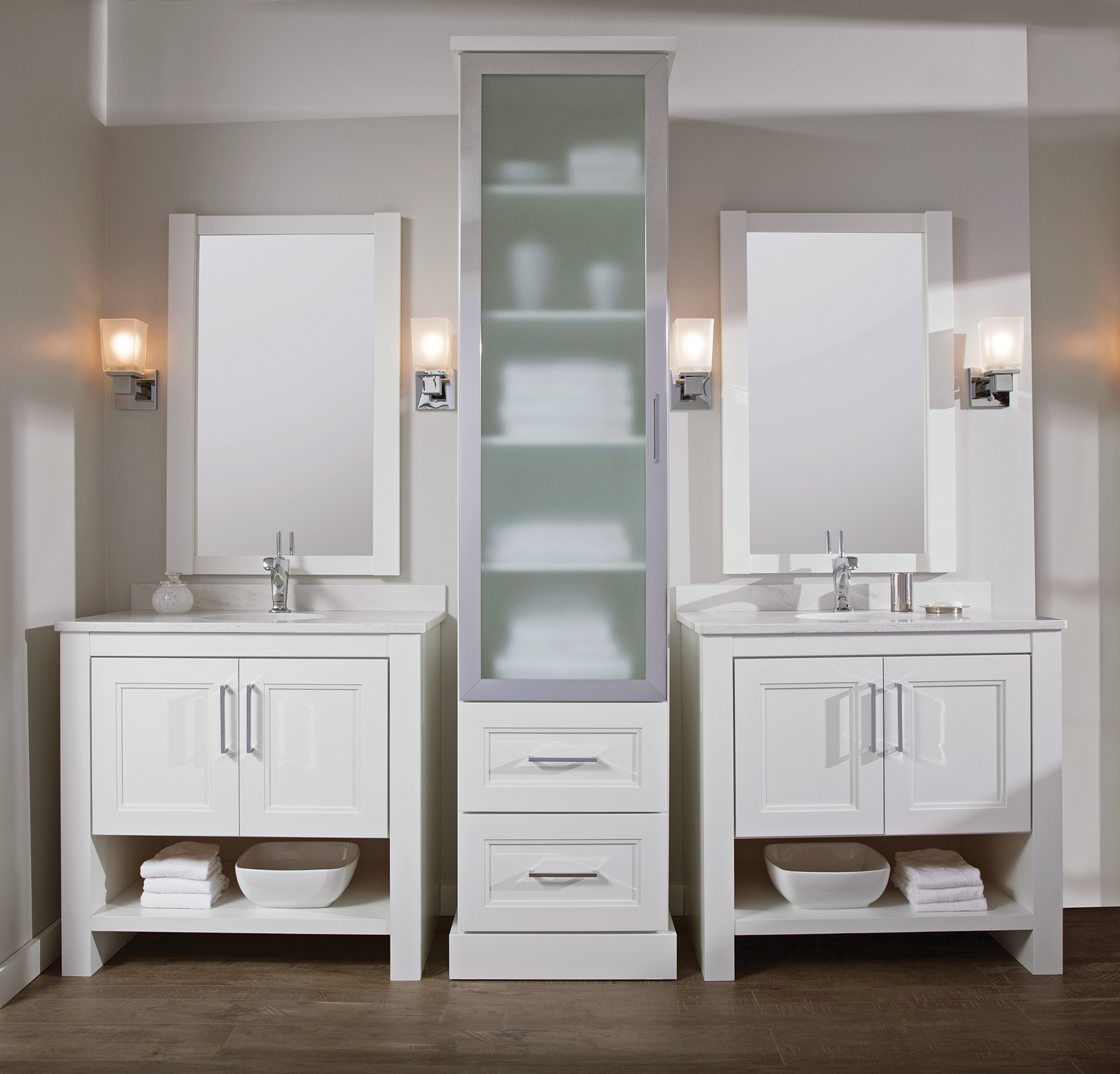 Dual vanities and a free standing linen cabinet between them make a coordinating bathroom furniture set.