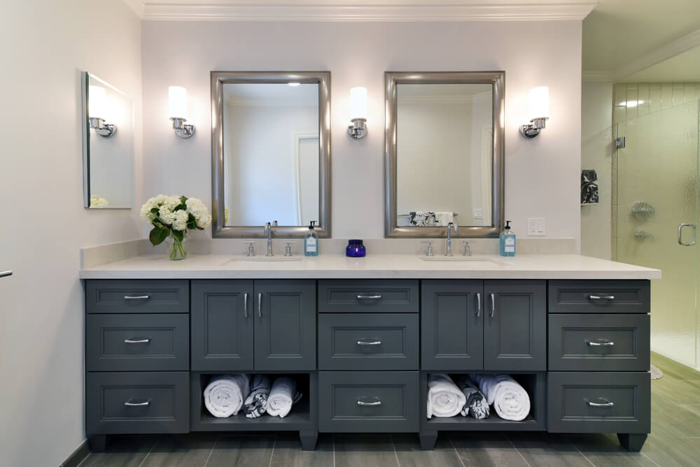 A dark painted bathroom vanity with two sinks and a furniture style.