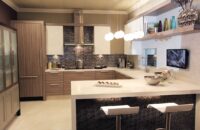 A gray contemporary kitchen design with a g-shaped layout.