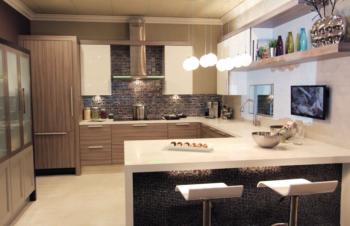 A gray contemporary kitchen design with a g-shaped layout.