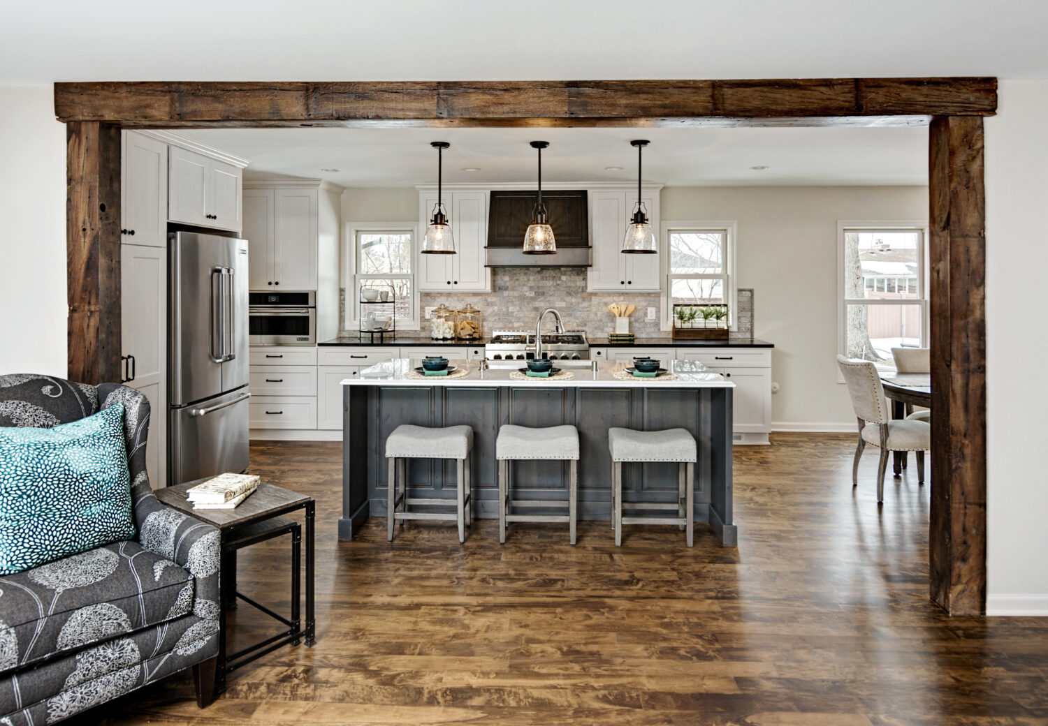 This full home remodel uses a shaker door style in a White paint color and raised panel door style in a gray stain on Knotty Alder as an accent.