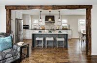 This full home remodel uses a shaker door style in a White paint color and raised panel door style in a gray stain on Knotty Alder as an accent.