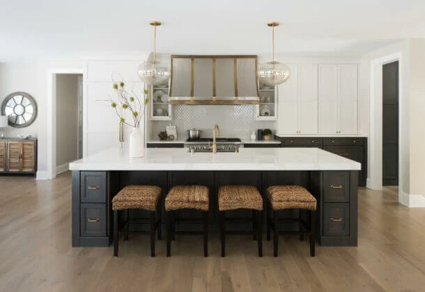 A modern farmhouse dream kitchen with dark gray stained oak for the base cabinets and white painted shaker wall cabinets.