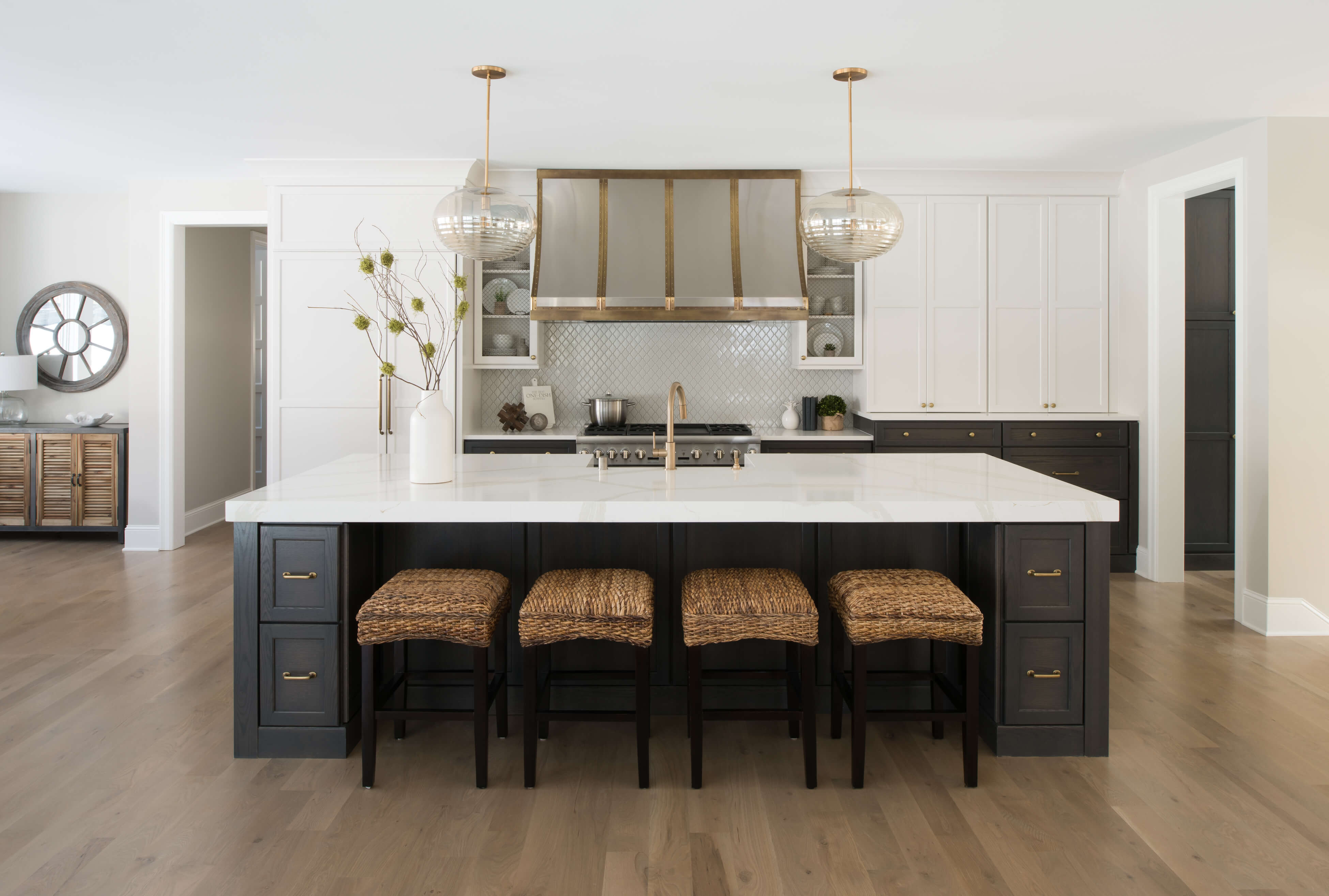 A modern farmhouse dream kitchen with dark gray stained oak for the base cabinets and white painted shaker wall cabinets.