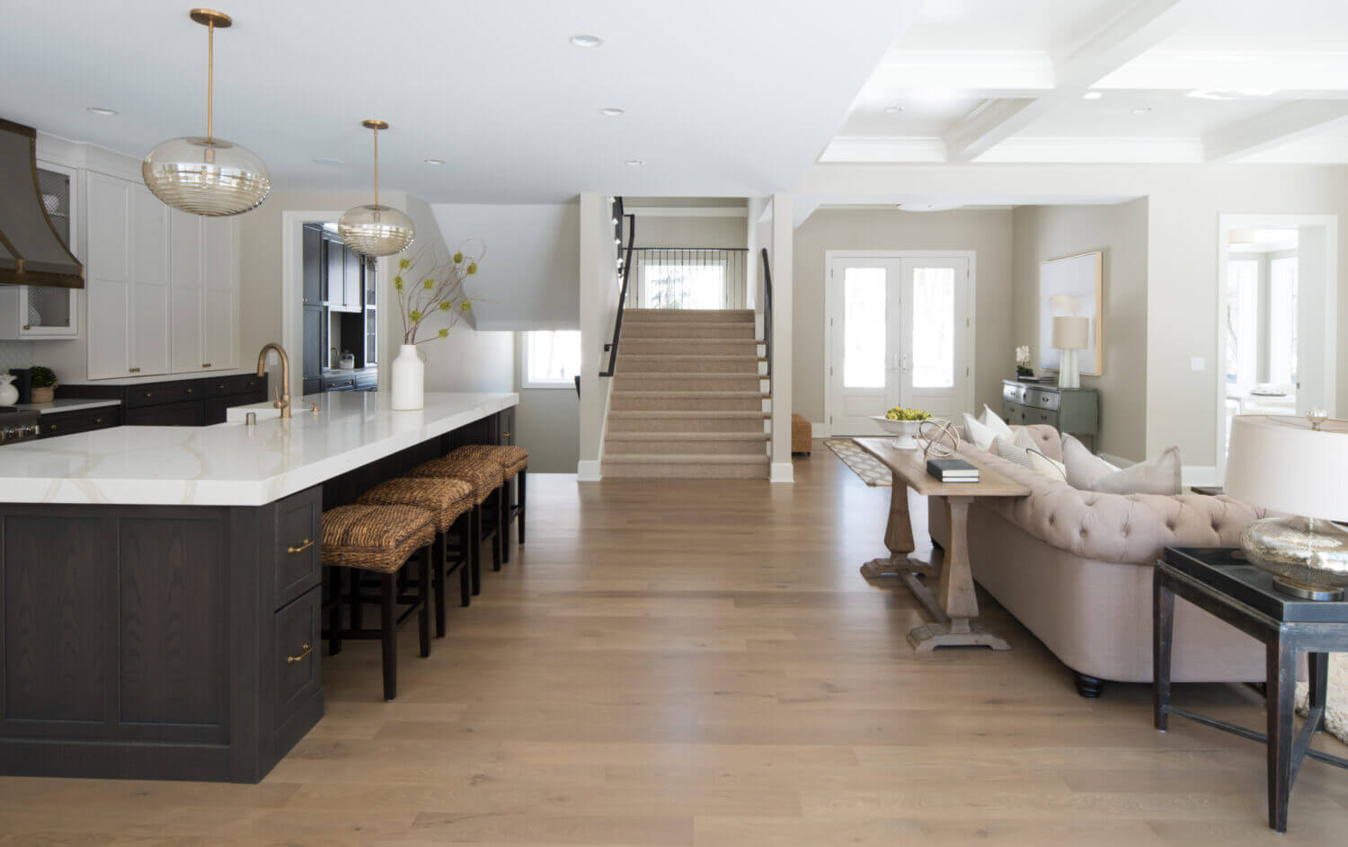 The kitchen island is the hub of the home. It sits along the main traffic walkway from two set of stairs and the traffic from the front door and living room.