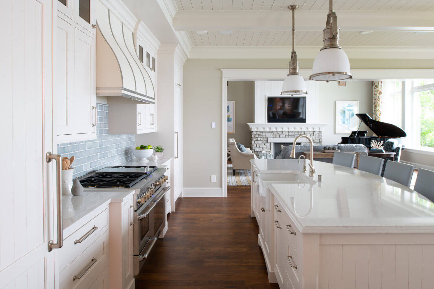 An East coast shingle styled kitchen with a symmetrical design using white painted inset cabinets and shiplap details.