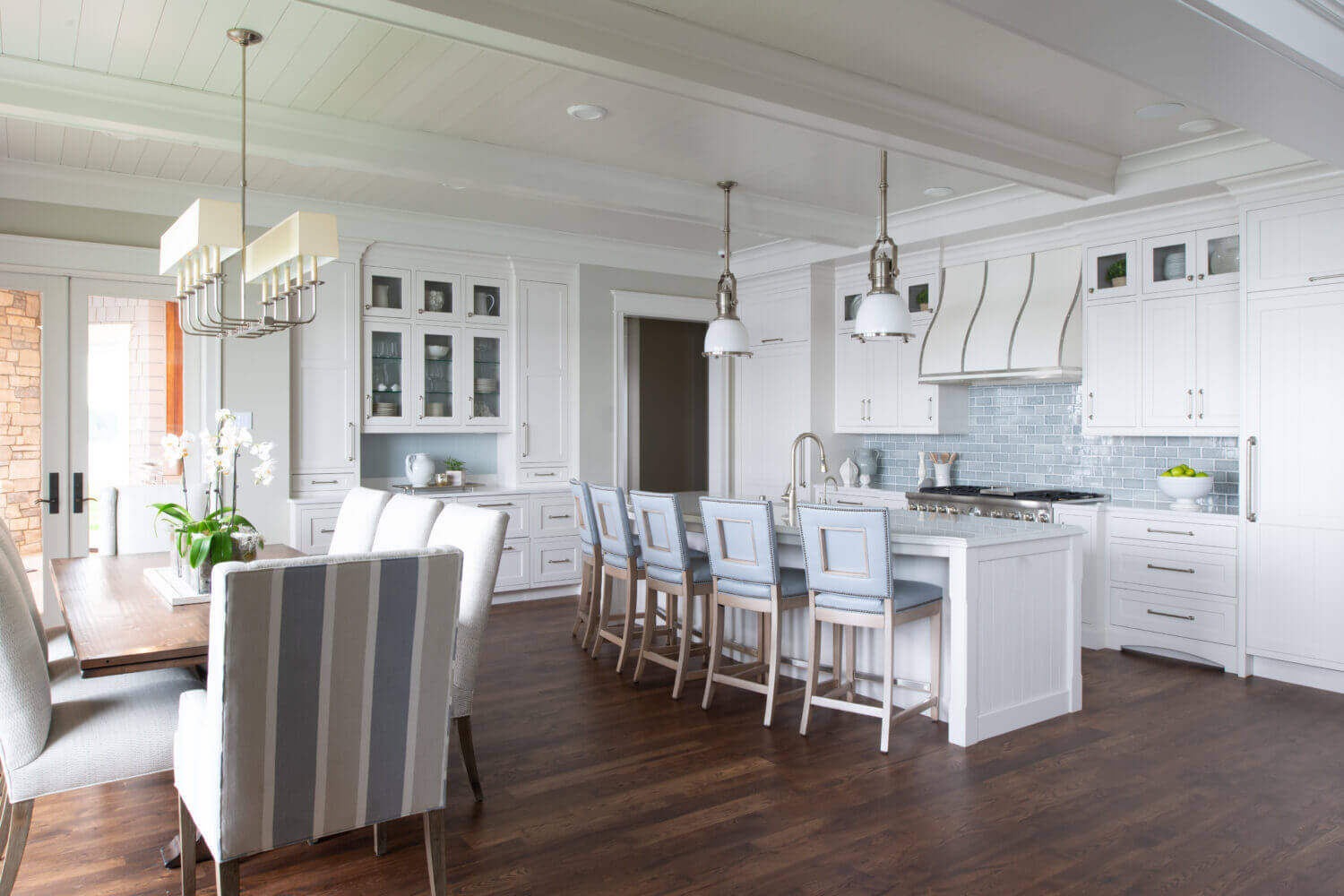 An all-white kitchen design with custom inset cabinets and shiplap and light blue accents.