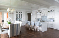 An all-white kitchen design with custom inset cabinets and shiplap and light blue accents.