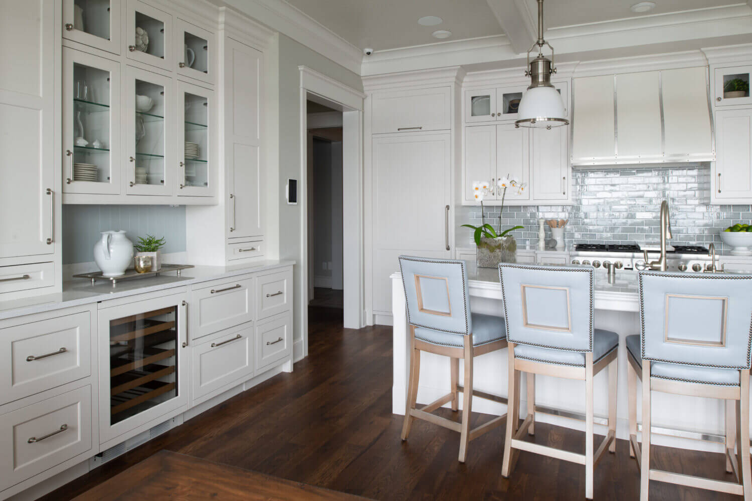A coastal style kitchen with white painted cabinets with inset construction and shaker style doors.