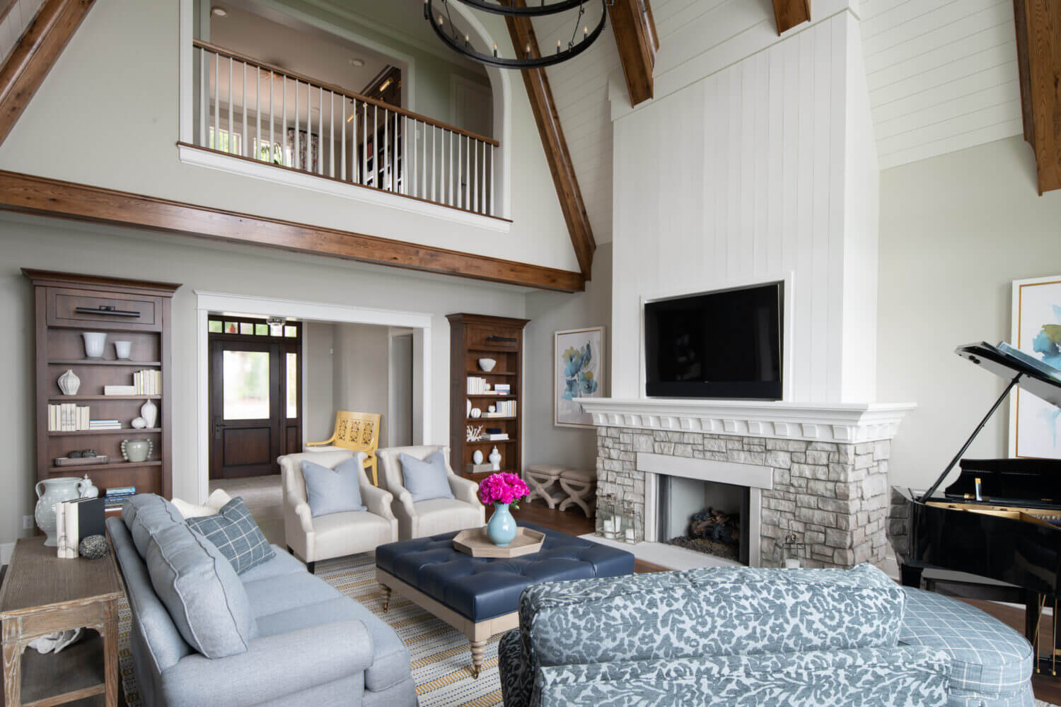 A coastal style living room with built-in bookcases and cabinetry from Dura Supreme with a beautiful fireplace design.