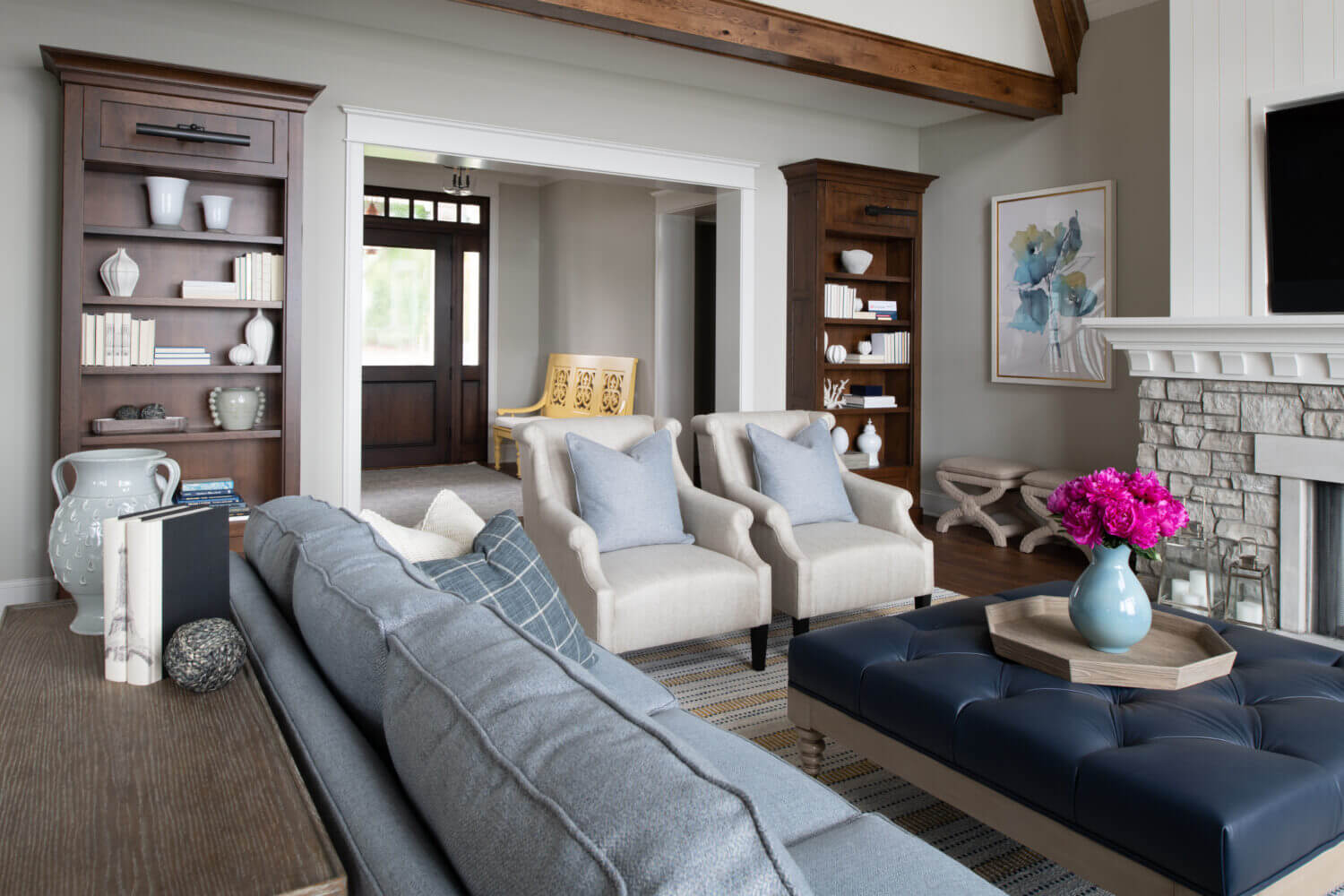 A coastal style living room with built-in bookcases and cabinetry from Dura Supreme.