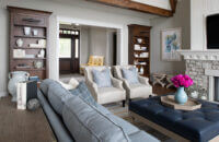 A coastal style living room with built-in bookcases and cabinetry from Dura Supreme.