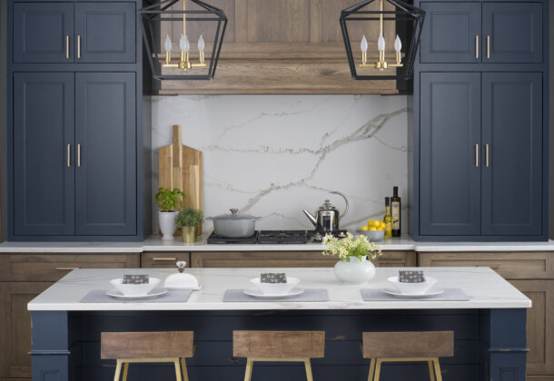 A colorful modern farmhouse kitchen with navy blue and gray stained hickory cabinets and a blue shiplap kitchen island.