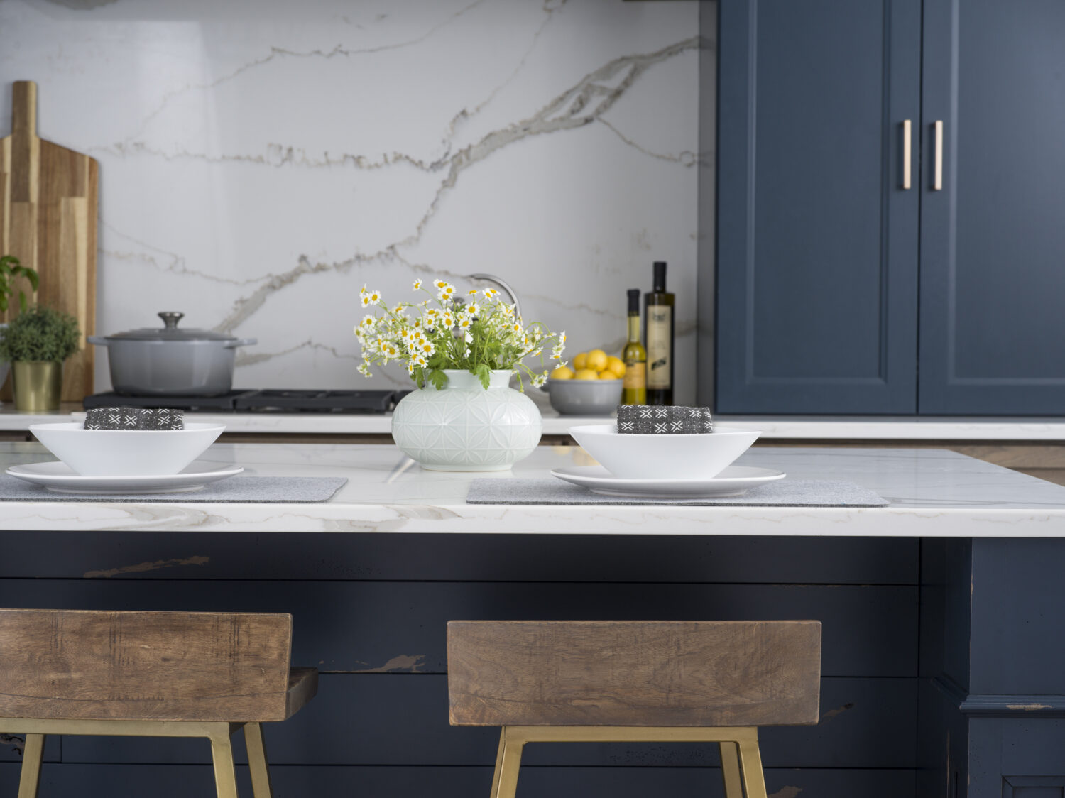 A close up of kitchen island seating at a navy blue kitchen island in a beautiful modern farmhouse kitchen.