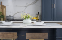 A close up of kitchen island seating at a navy blue kitchen island in a beautiful modern farmhouse kitchen.