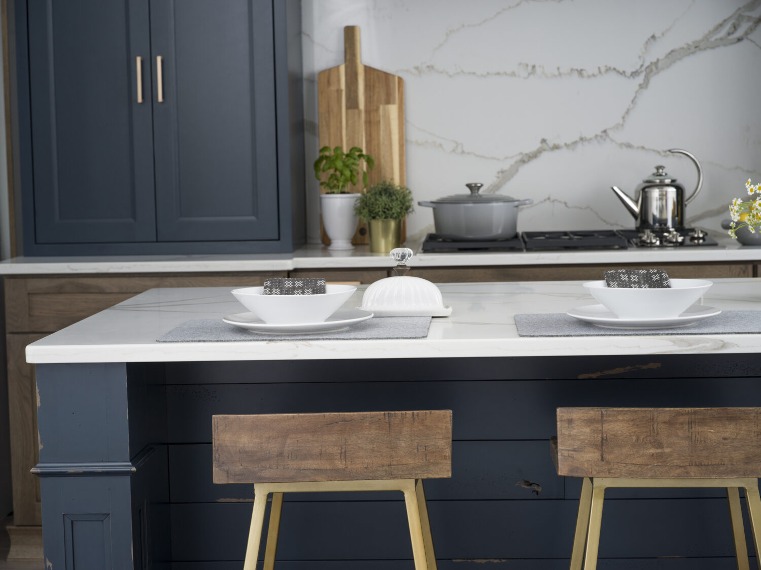 A dark blue kitchen island with shiplap details in a modern farmhouse style kitchen.