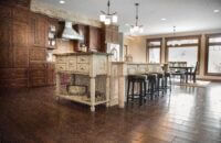 A large single wall kitchen with a kitchen island with a traditional country style featuring a rustic kitchen island.