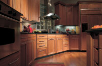 This practical and intelligent cherry wood kitchen design creates cabinetry that performs as beautifully as it looks with a warm cozy color palette.