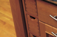 Vertical apothecary drawers in a cherry wood kitchen island with a rich-warm stain color. Kitchen island cabinets and storage from Dura Supreme.