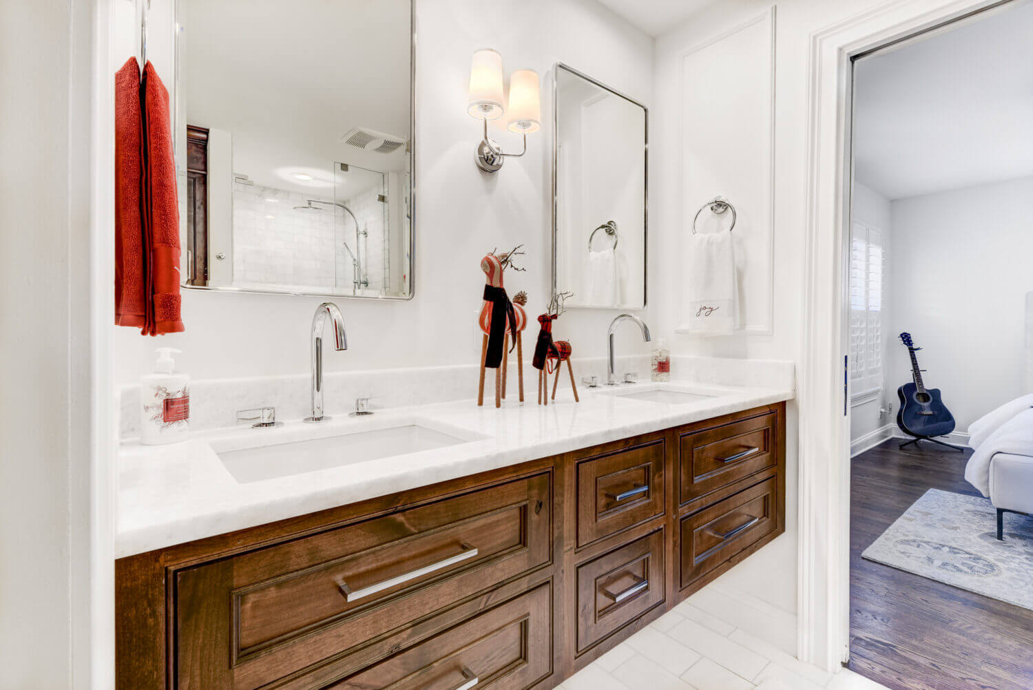 A warm, knotty alder floating bath vanity with inset cabinet doors in a remodeled master bathroom. This bath is decorated with festive red, reindeer holiday decor.