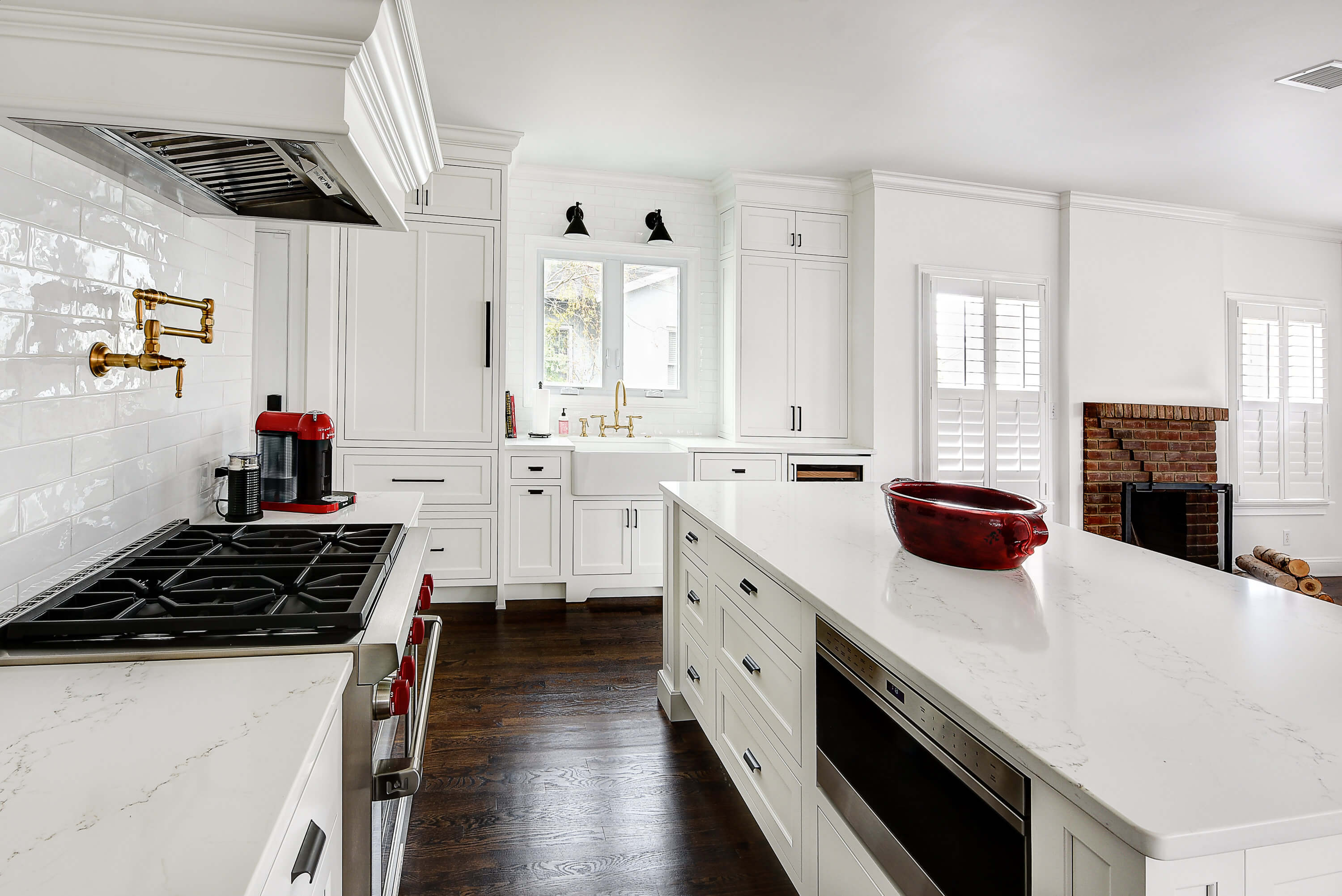 A bright white kitchen remodel with a large space for the kitchen sink and cooking area.