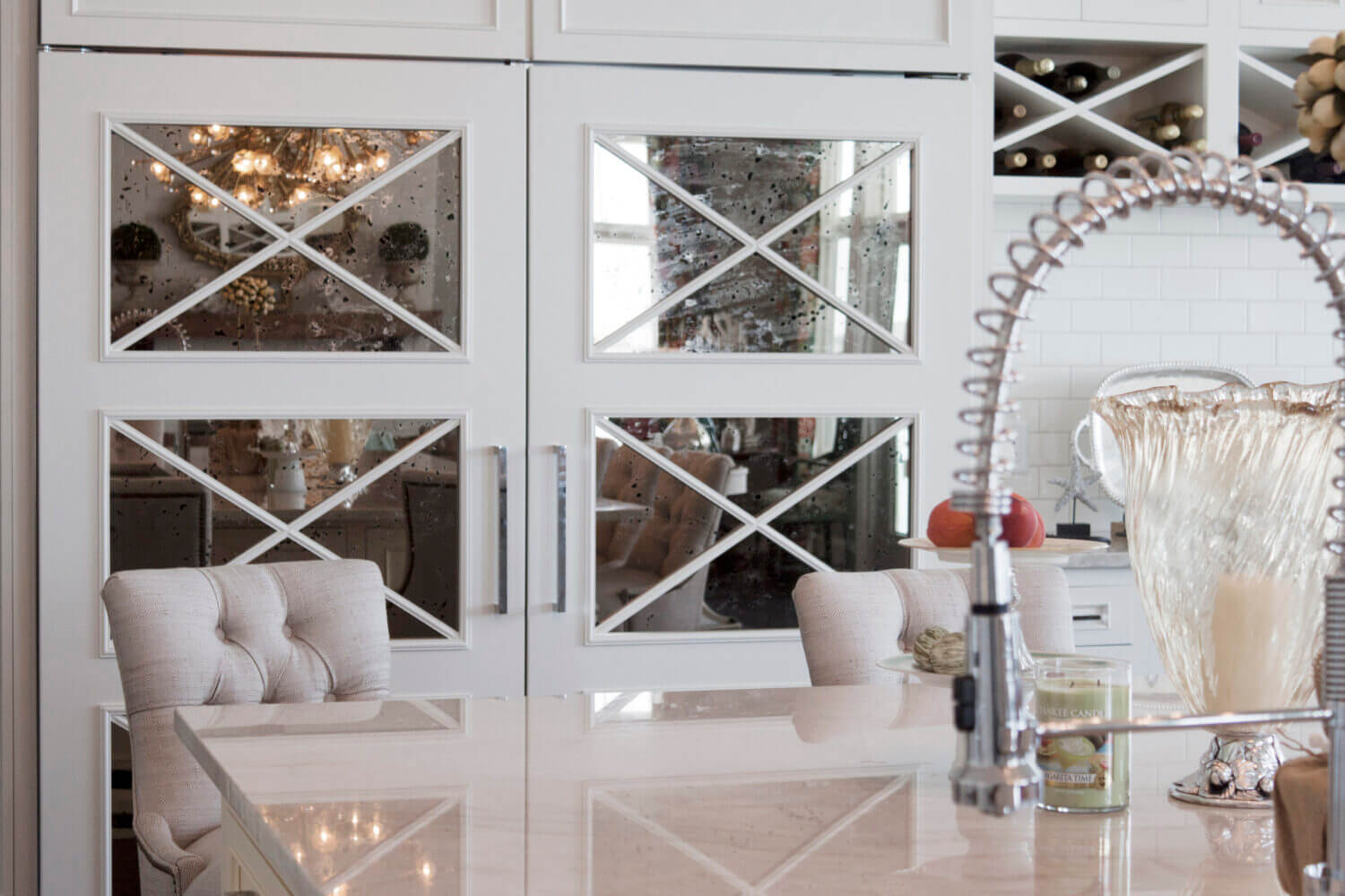 Antique mirror cabinet doors with an X mullion used on an appliance paneled appliance to hide the refrigerator.