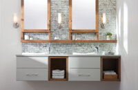 A two-toned floating vanity with light gray paint and warm stained wood with open storage and a floating shelf connecting to the dual medicine cabinets with a modern design.