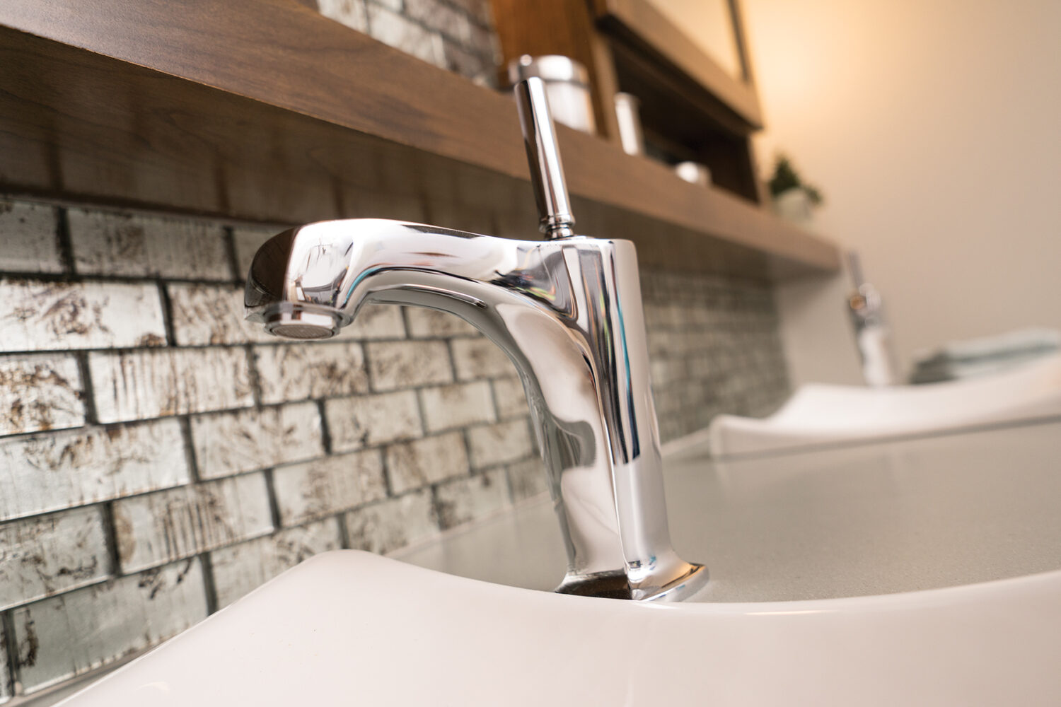 An off-set bathroom sink faucet in a modern bathroom.