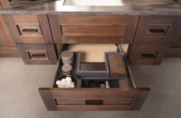 A Plumbing Drawer in Stainless Steel that creates more storage under the sink.