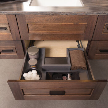 A Plumbing Drawer in Stainless Steel that creates more storage under the sink.