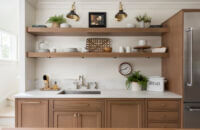 A wall with light oak base cabinets and sleek, simple floating shelves instead of wall cabinets.