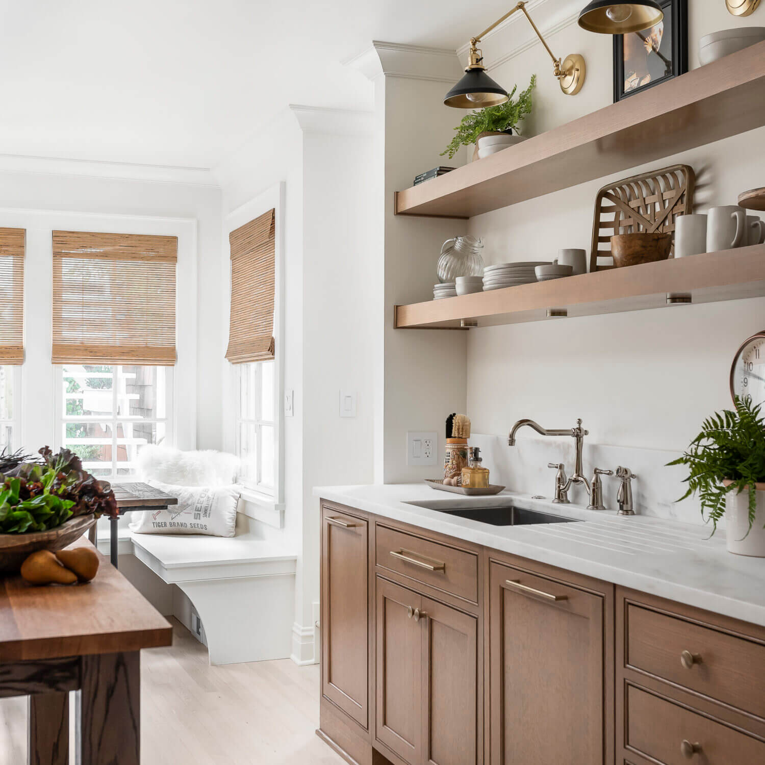 A pretty light oak stain color on a row of base cabinets and a set of floating shelves.